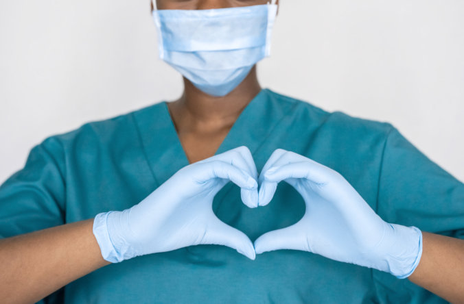 nurse doing heart using two hands