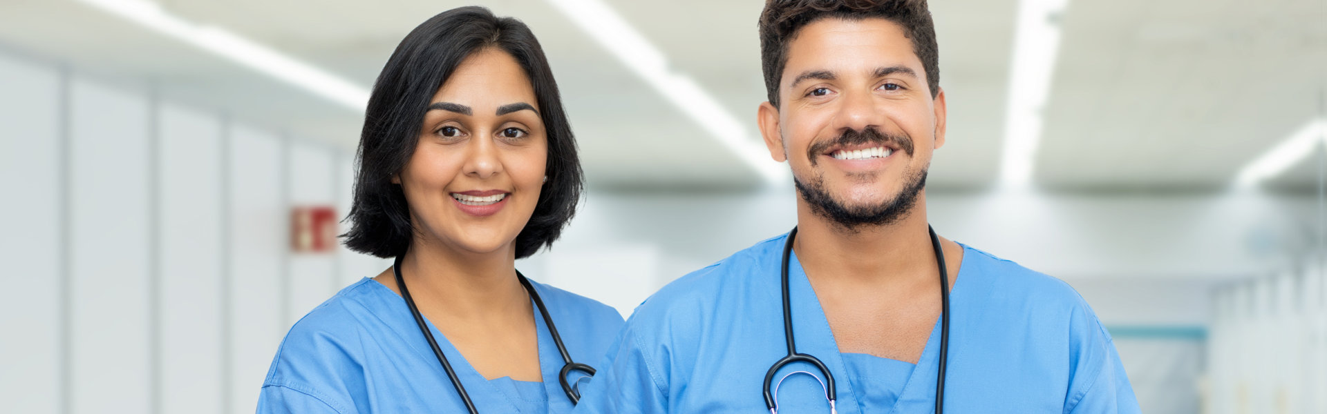 male and female nurse smiling
